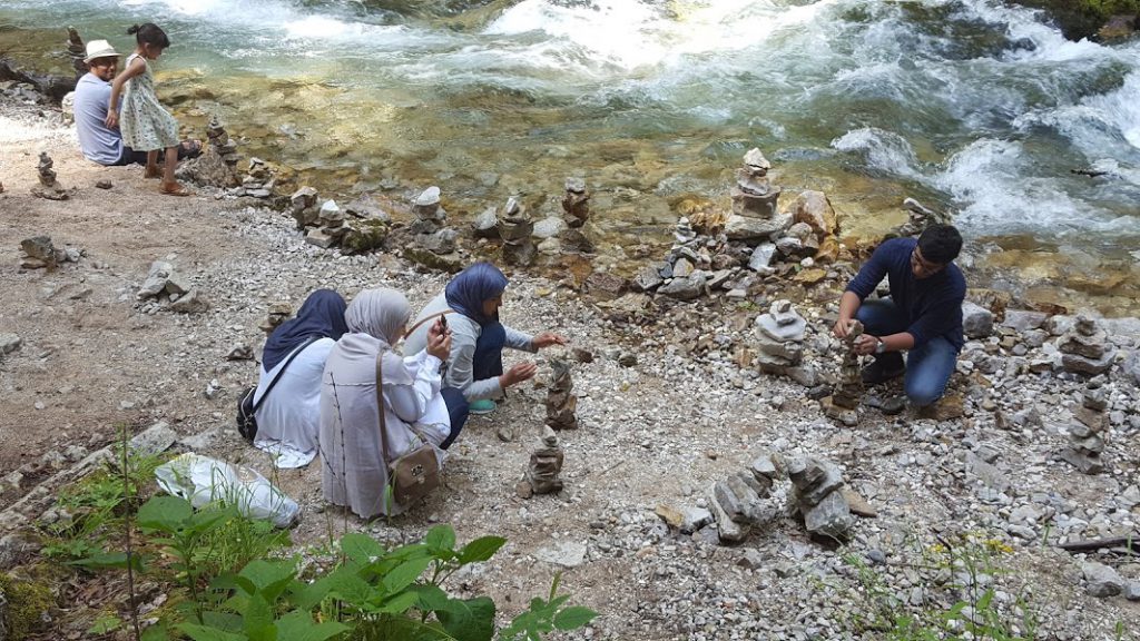 people stacking rocks in Vintgar gorge