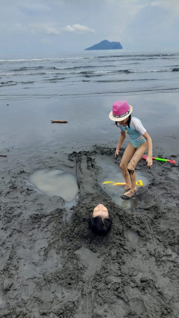 sisters play in the sand